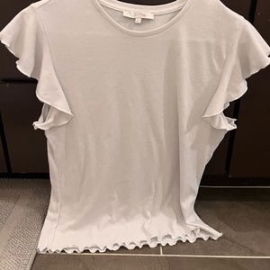 White blouse with ruffles on sleeves and bottom of shirt- tighter and cropped.